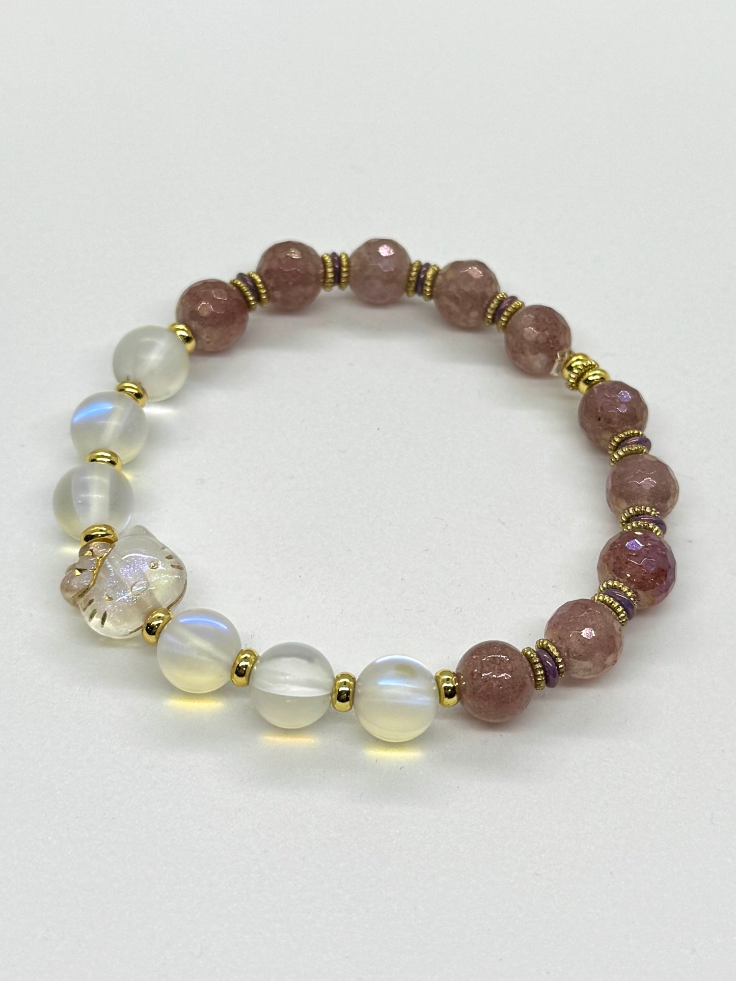 Beaded bracelet with pink and white beads on a light gray background