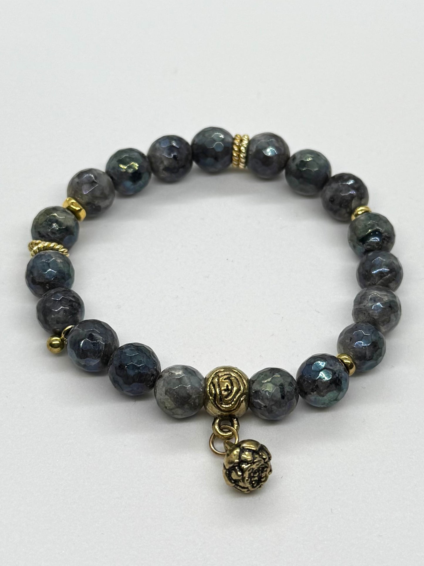 Bracelet with gray beads and gold accents on a white background