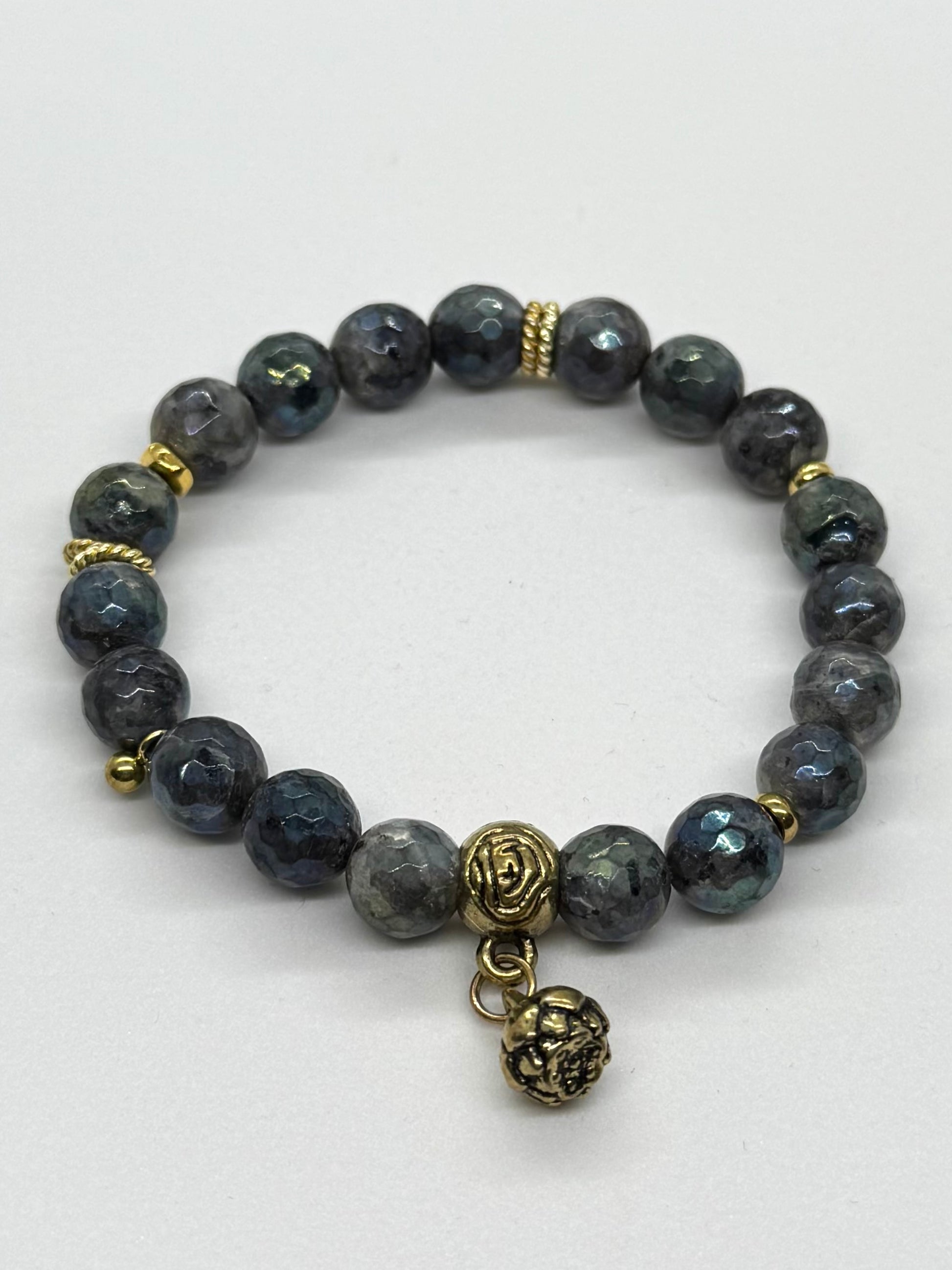 Bracelet with gray beads and gold accents on a white background
