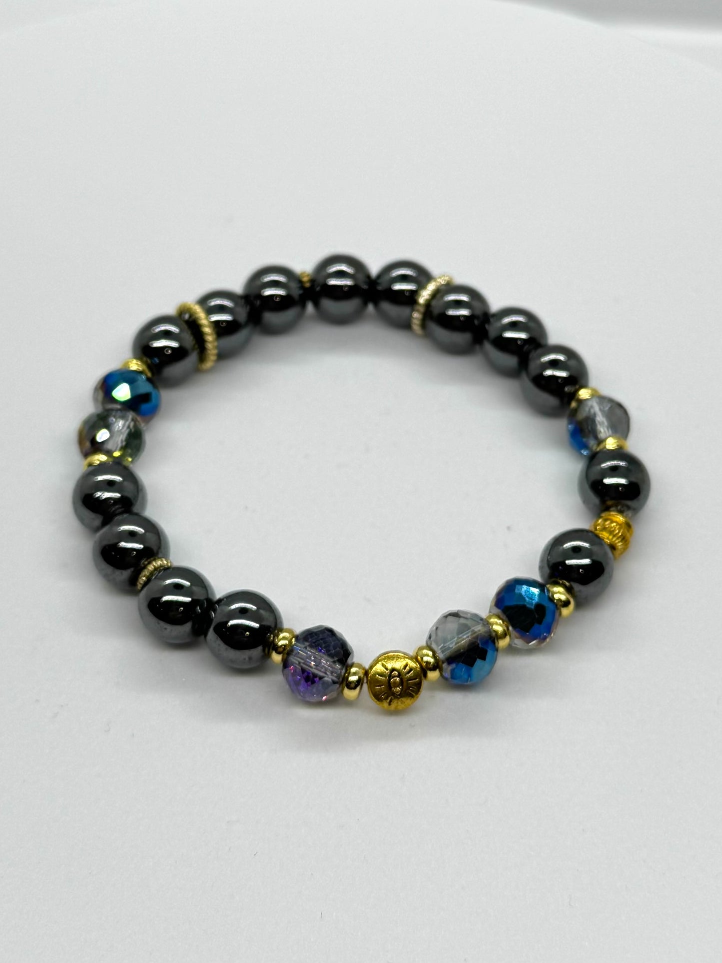 Beaded bracelet with black, blue, and gold beads on a white background