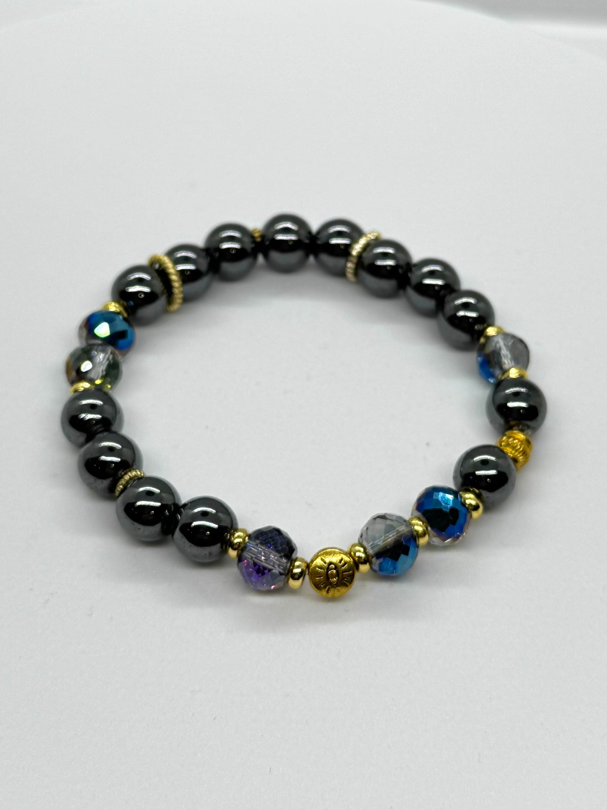 Beaded bracelet with black, blue, and gold beads on a white background