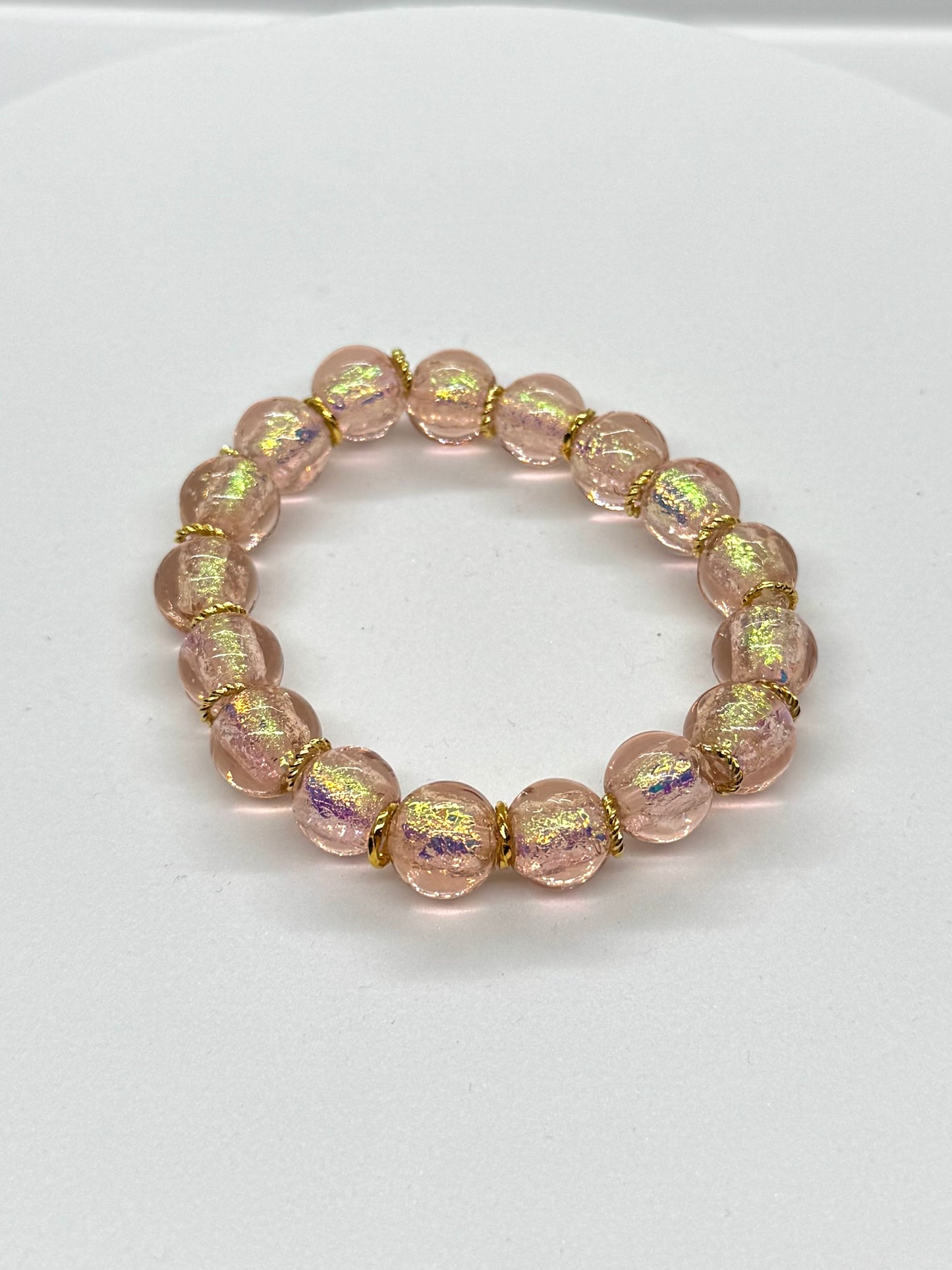 Pink beaded bracelet on a white background