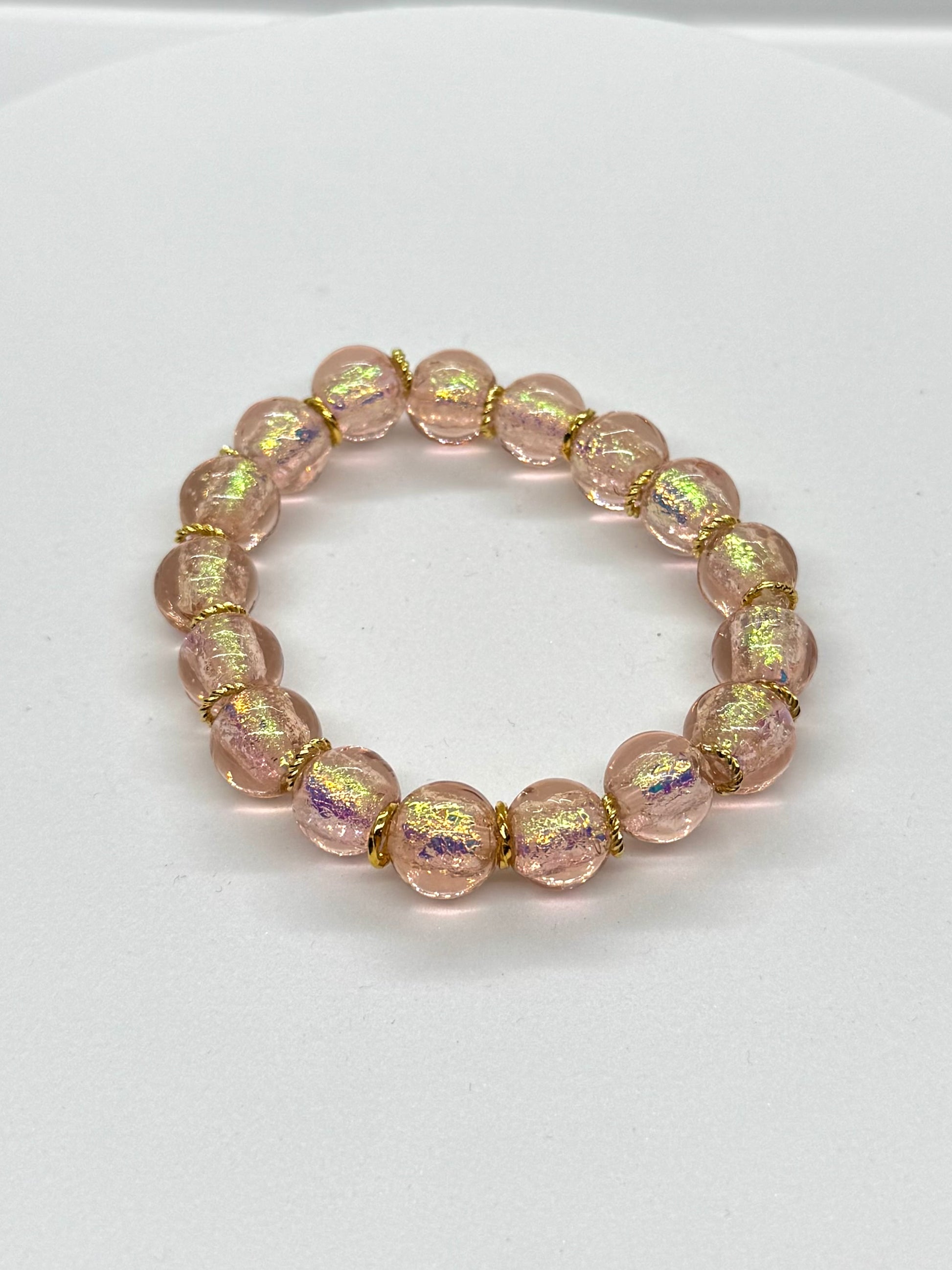 Pink beaded bracelet on a white background