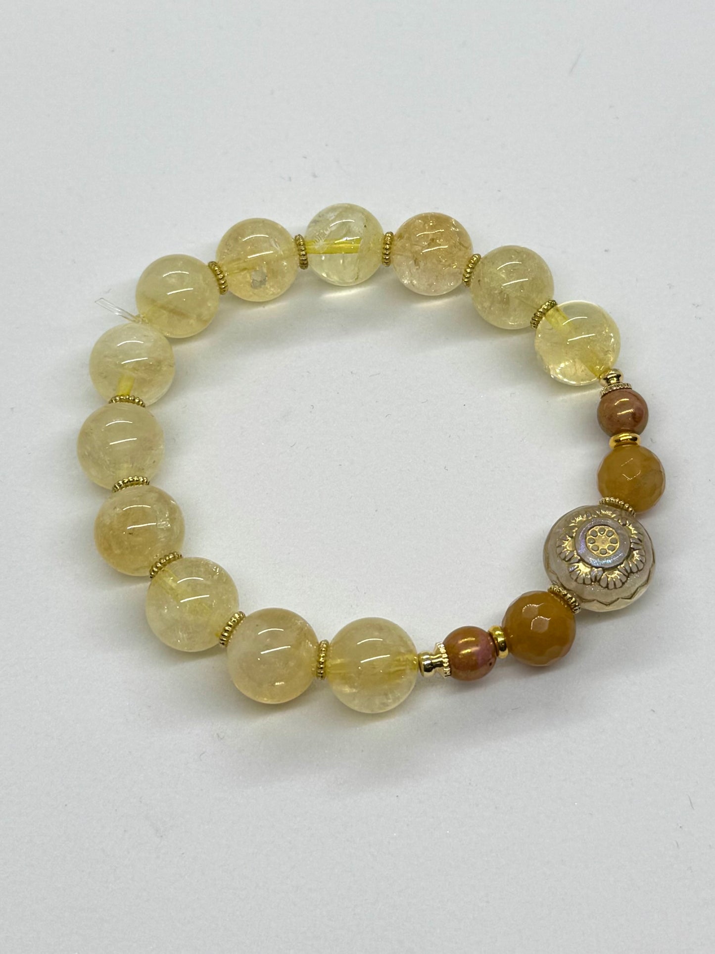 Beaded bracelet with yellow and brown beads on a white background