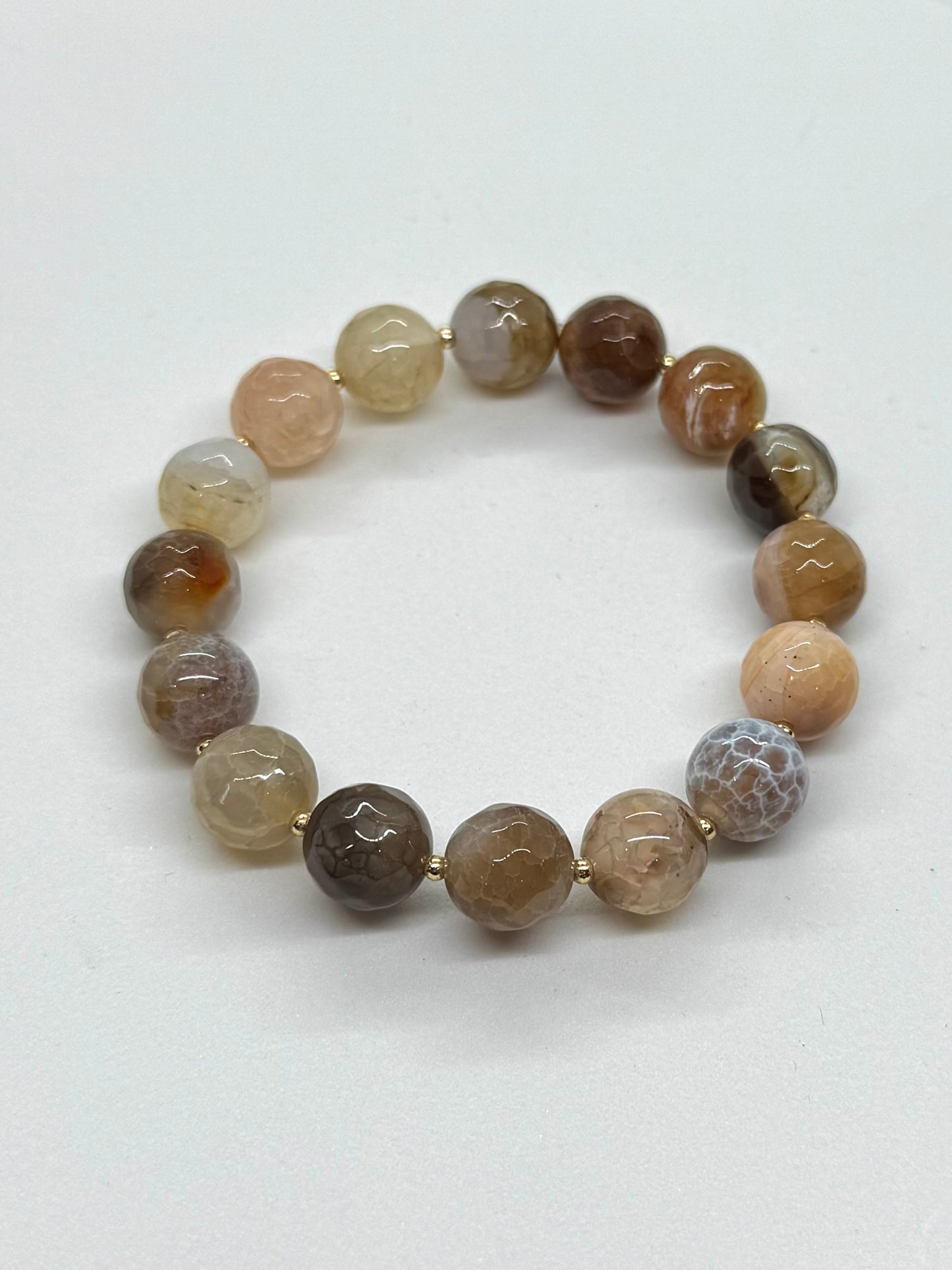 Beaded bracelet with brown and beige stones on a white background