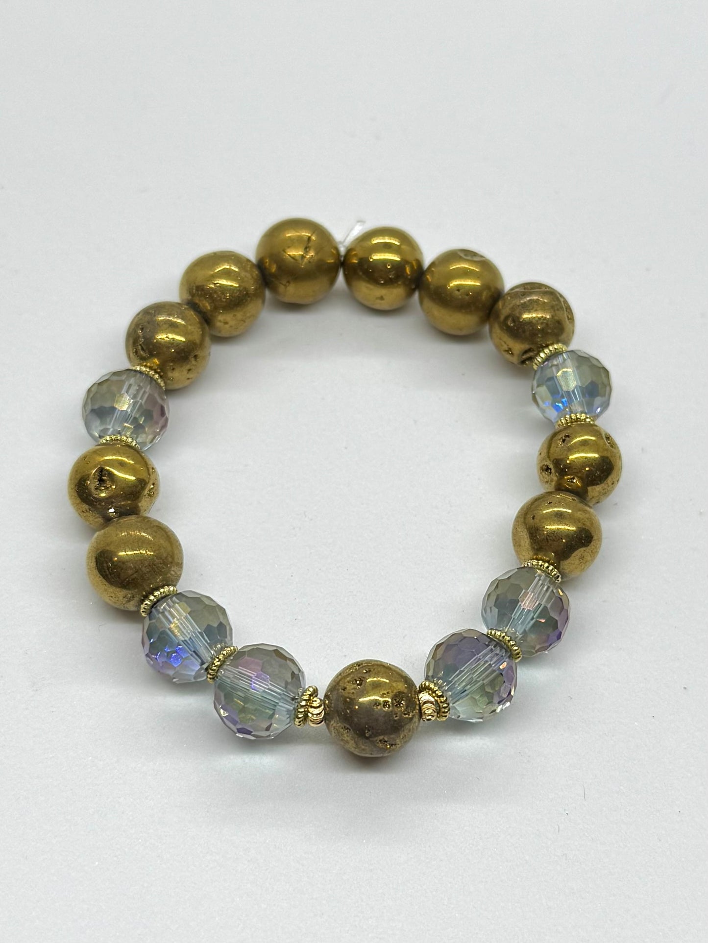 Bracelet with gold and clear beads on a white background