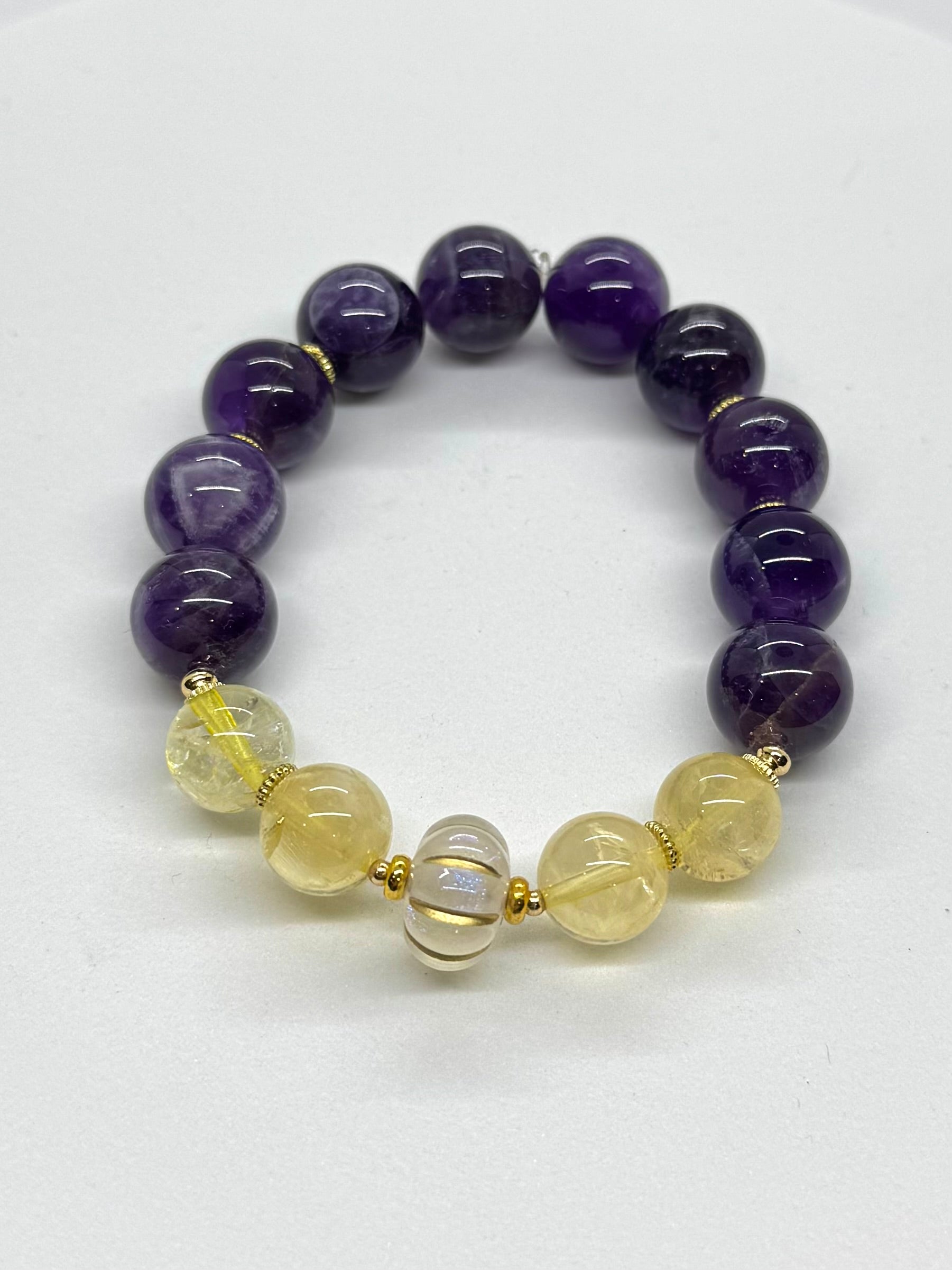 Bracelet with purple and yellow beads on a white background