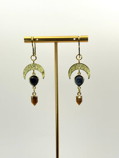 Pair of earrings with green crescent moon and brown teardrop design on a white background