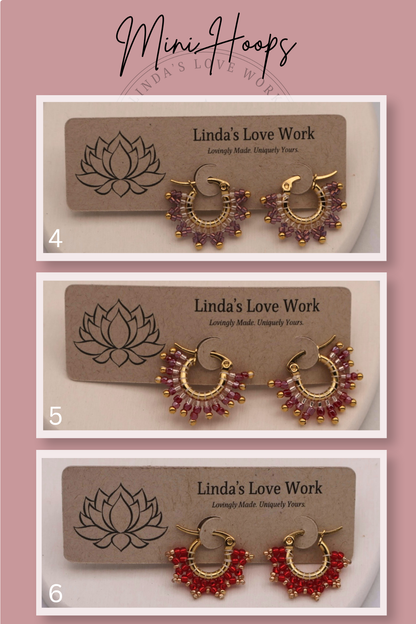 Three pairs of hoop earrings on 'Linda's Love Work' branded cards with a pink background.