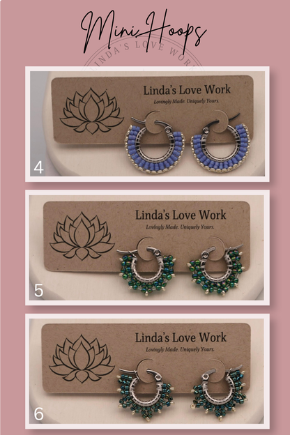 Three pairs of hoop earrings on 'Linda's Love Work' branded cards against a pink background.