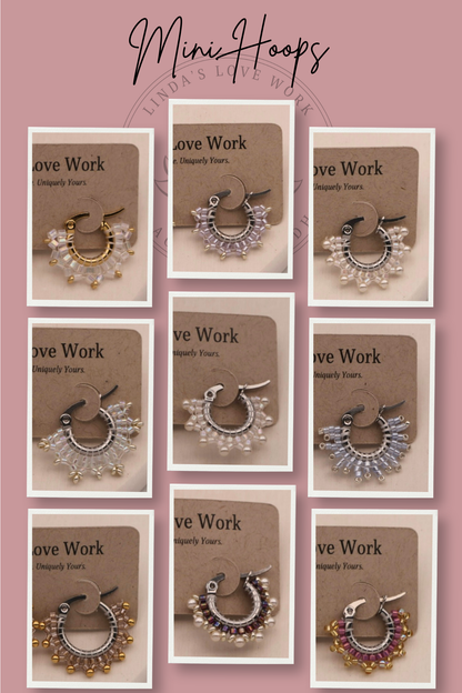 Mini hoop earrings on branded cards with a pink background