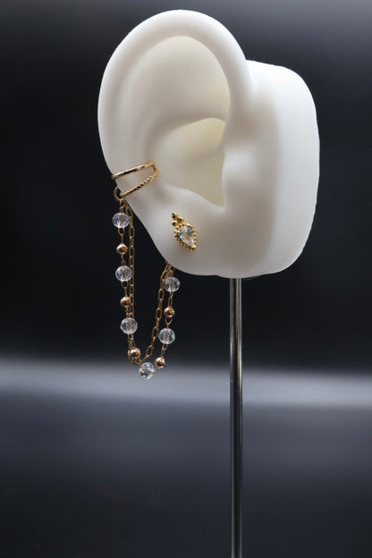 Earring displayed on a white ear model with a dark background