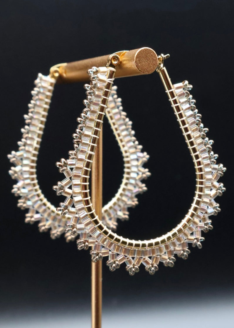 Pair of silver hoop earrings on a black background