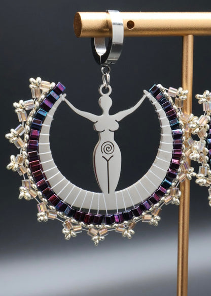Decorative pendant with a central figure and colorful circular design on a stand.