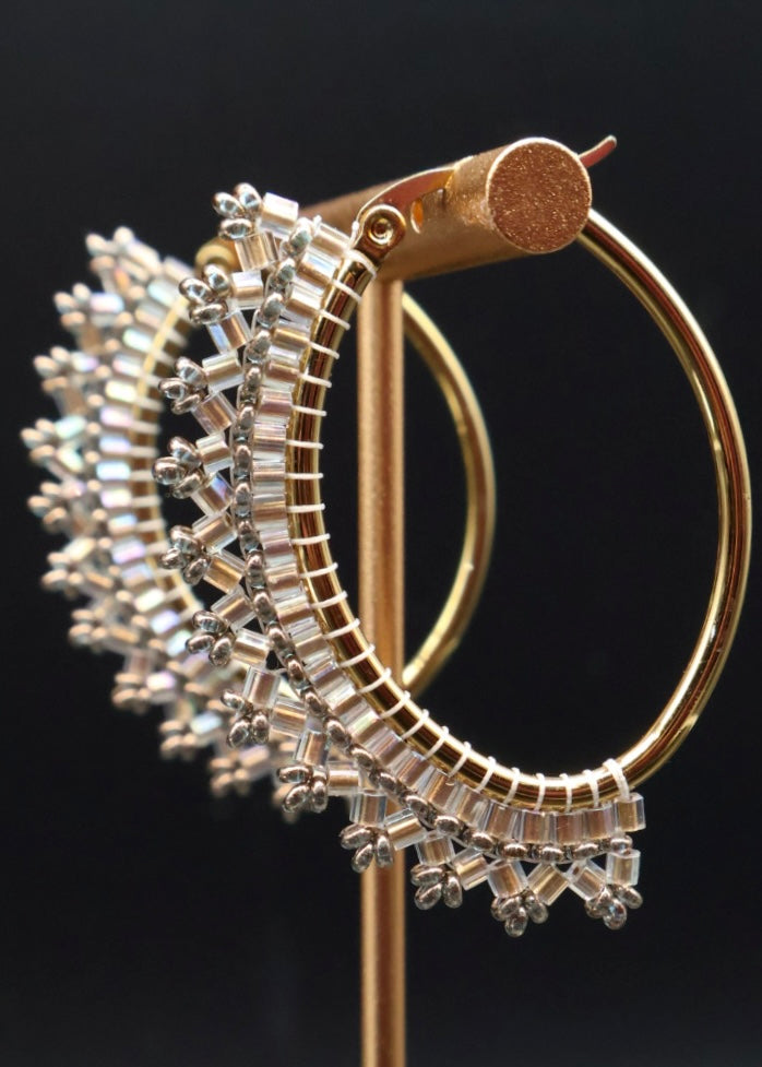 Gold and silver hoop earrings on a black background
