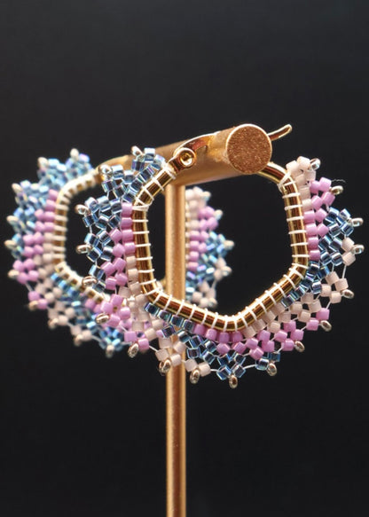 Decorative brooch with multicolored beads on a black background