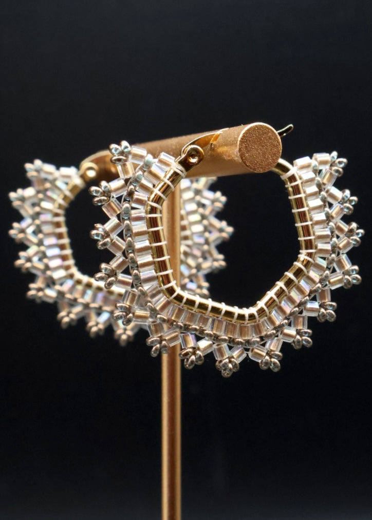 Gold and silver hoop earrings on a black background