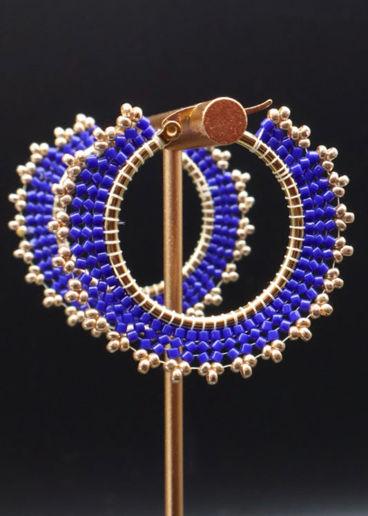 Earring with blue and silver bead design on a black background