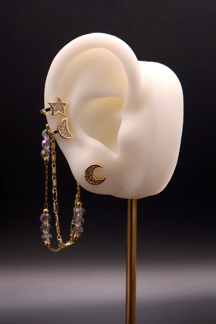 Earring displayed on a white ear model with a dark background