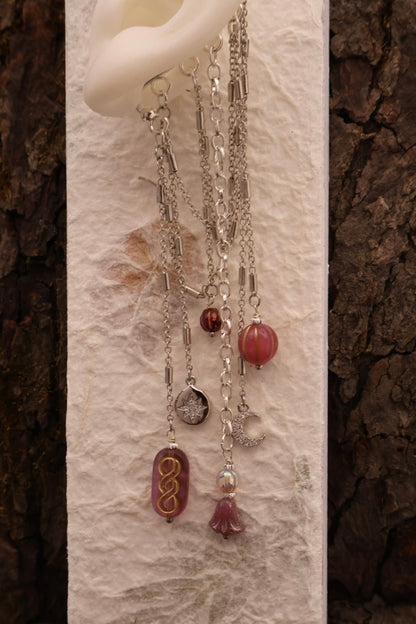 Necklace with various pendants on a textured white surface