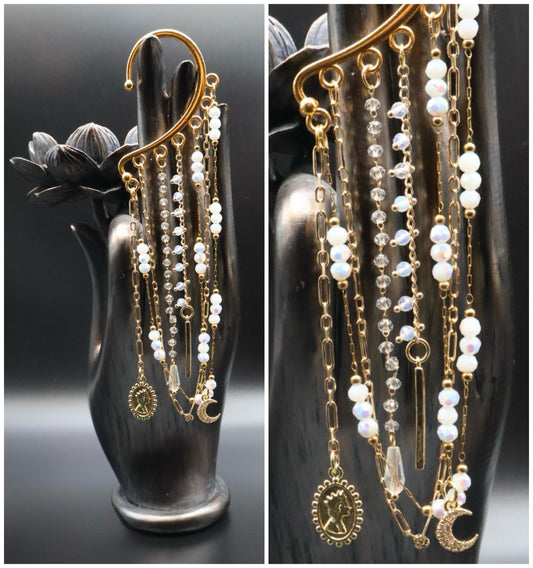 Delicate gold and pearl necklace on a black mannequin bust against a dark background