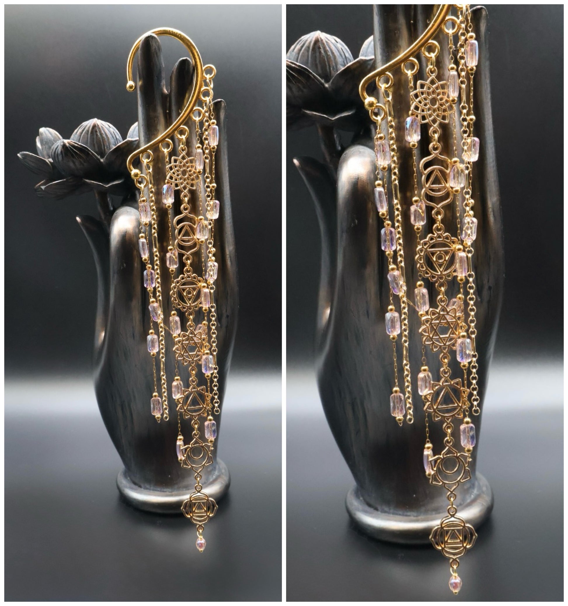 Gold and crystal earrings on a black hand-shaped stand against a dark background