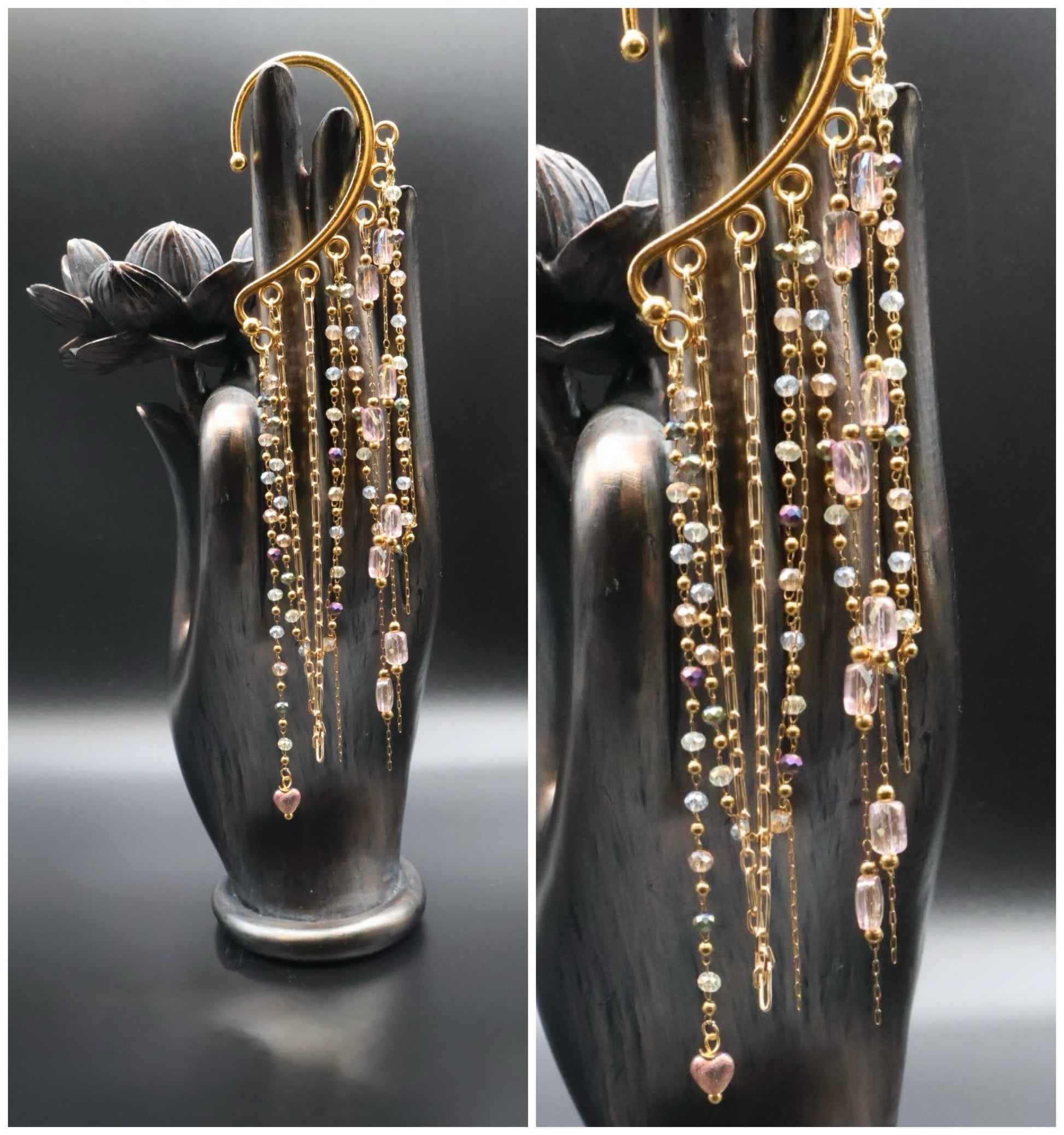 Gold and crystal drop earrings on a black hand-shaped stand against a dark background