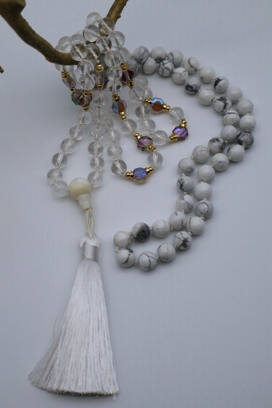 Beaded necklace with tassel on a light gray background