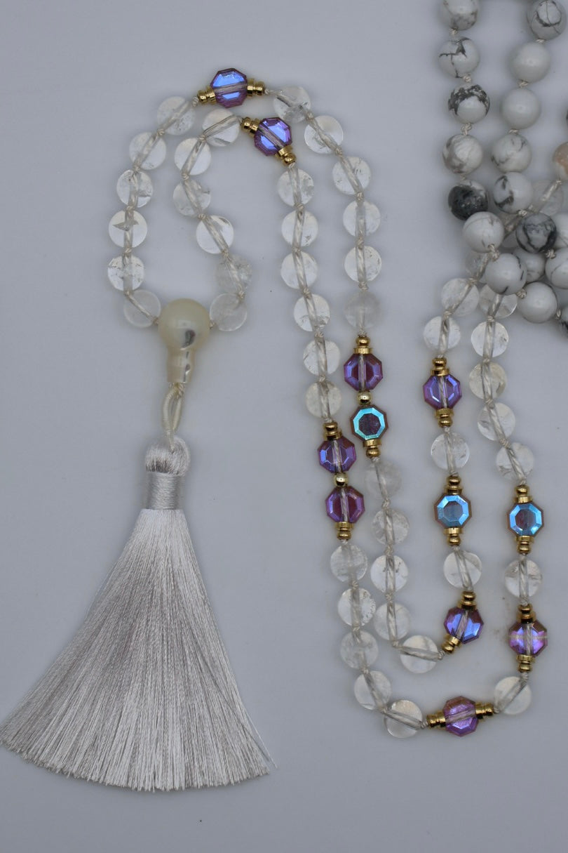 Beaded necklace with tassel on a light gray background