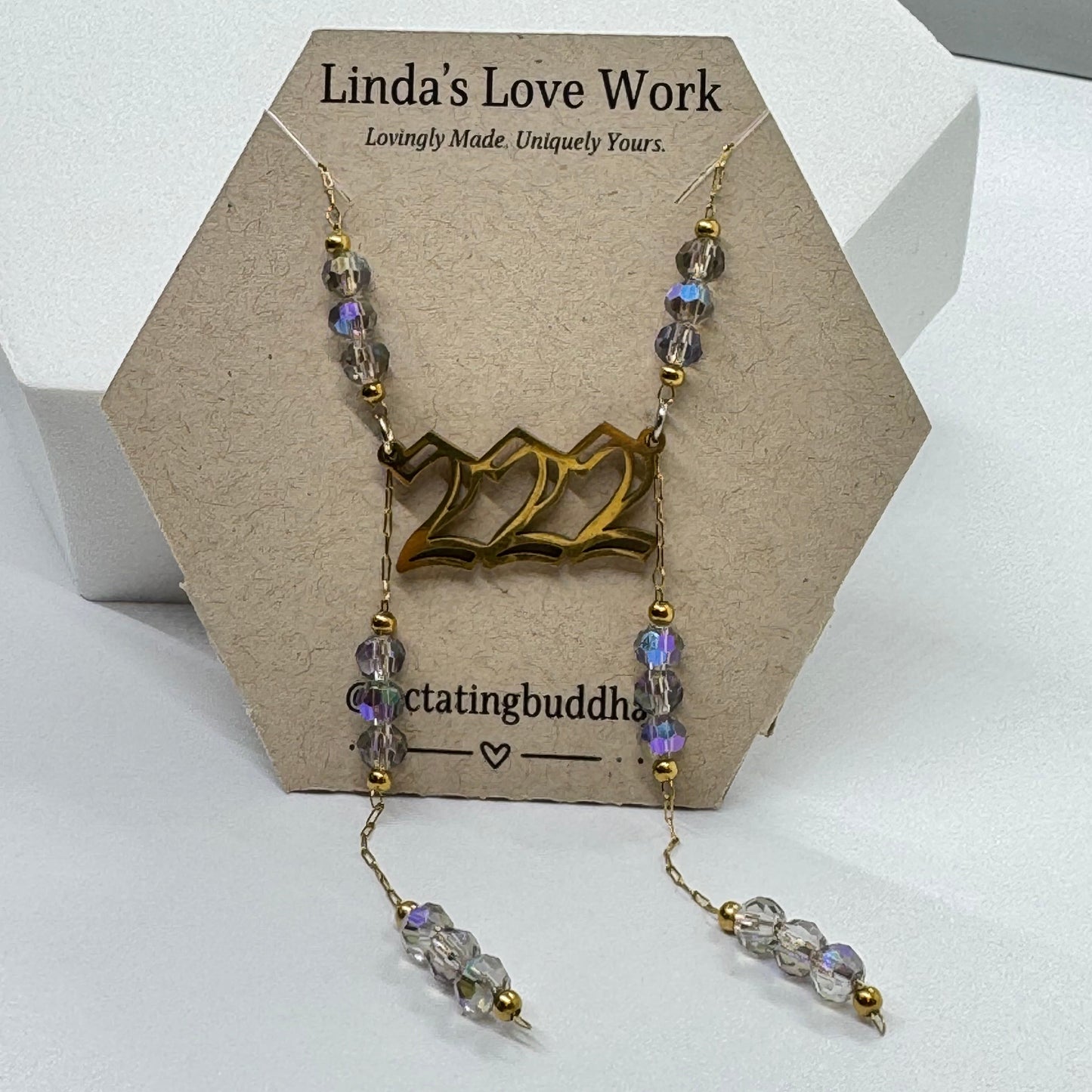 Necklace with beads on a card with 'Linda's Love Work' branding
