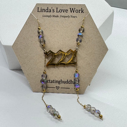 Necklace with beads on a card with 'Linda's Love Work' branding