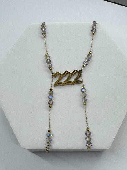Necklace with '22' pendant on a white stand