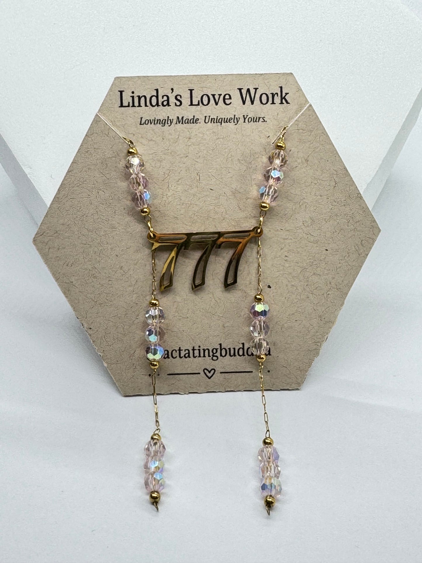 Necklace with beads on a hexagonal card with 'Linda's Love Work' branding.