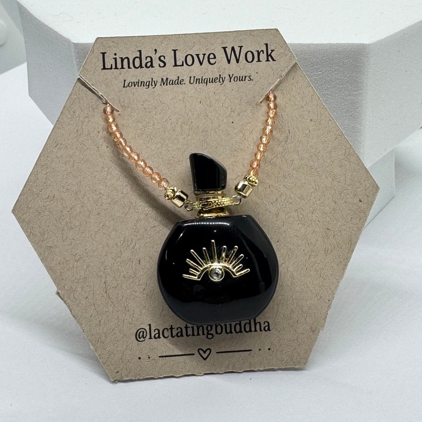 Black and gold necklace on a branded card with 'Linda's Love Work' text.