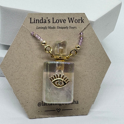 Small clear container with gold and purple accents on a branded card