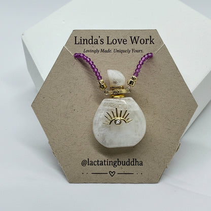 Decorative item with purple beads and gold accents on a hexagonal cardboard stand with 'Linda's Love Work' branding.