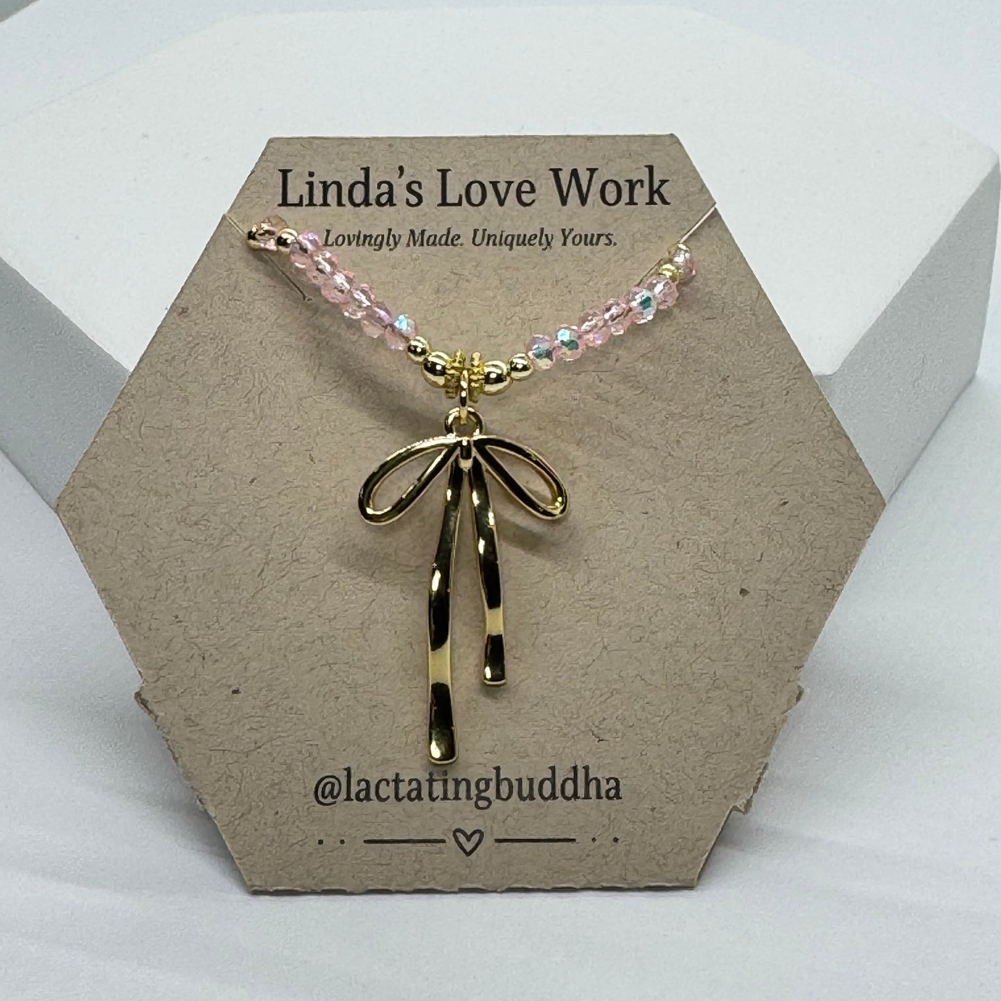 necklace on a branded card with a white background