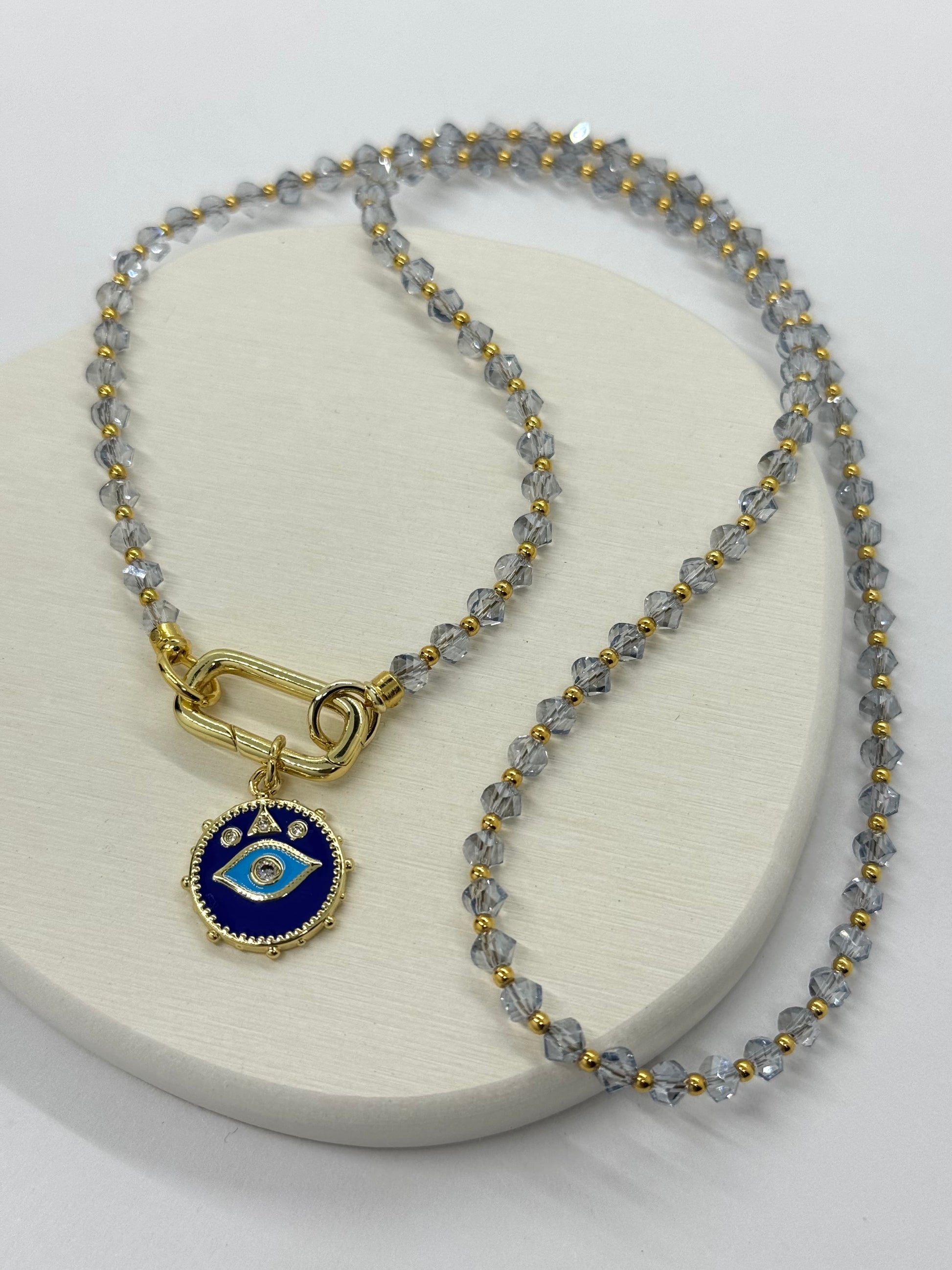 Necklace with blue pendant on a white surface