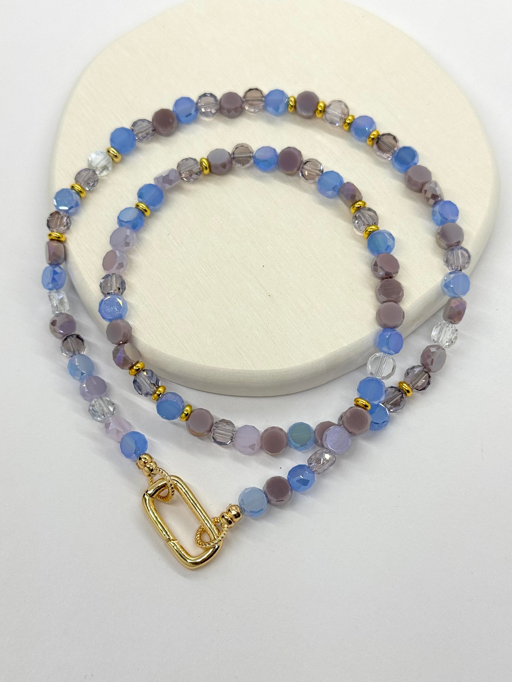 Beaded necklace with a gold clasp on a white background