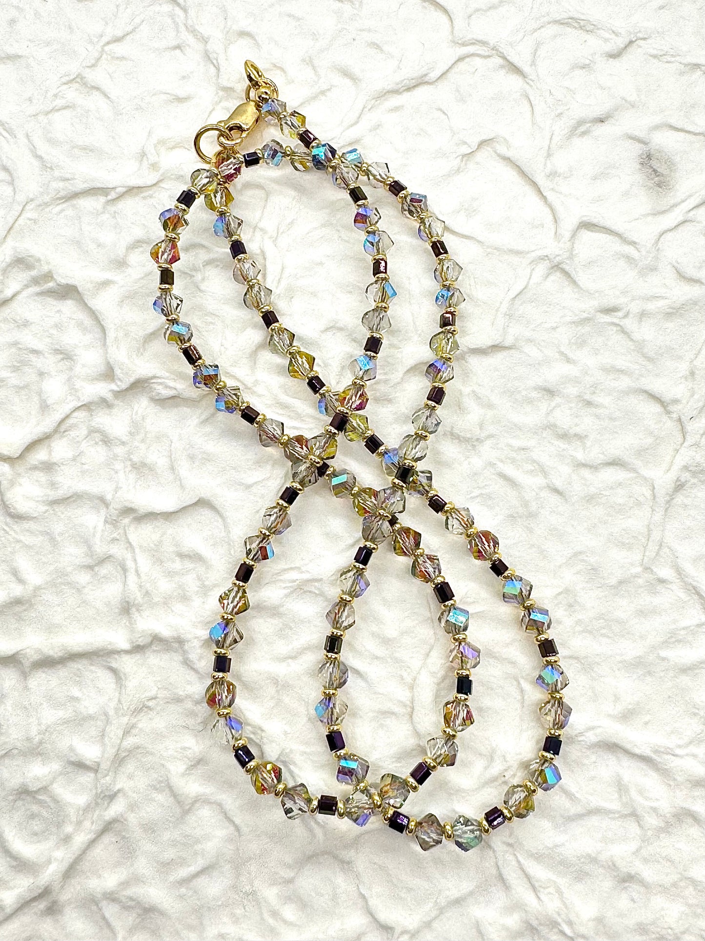 Beaded necklace on a textured white surface