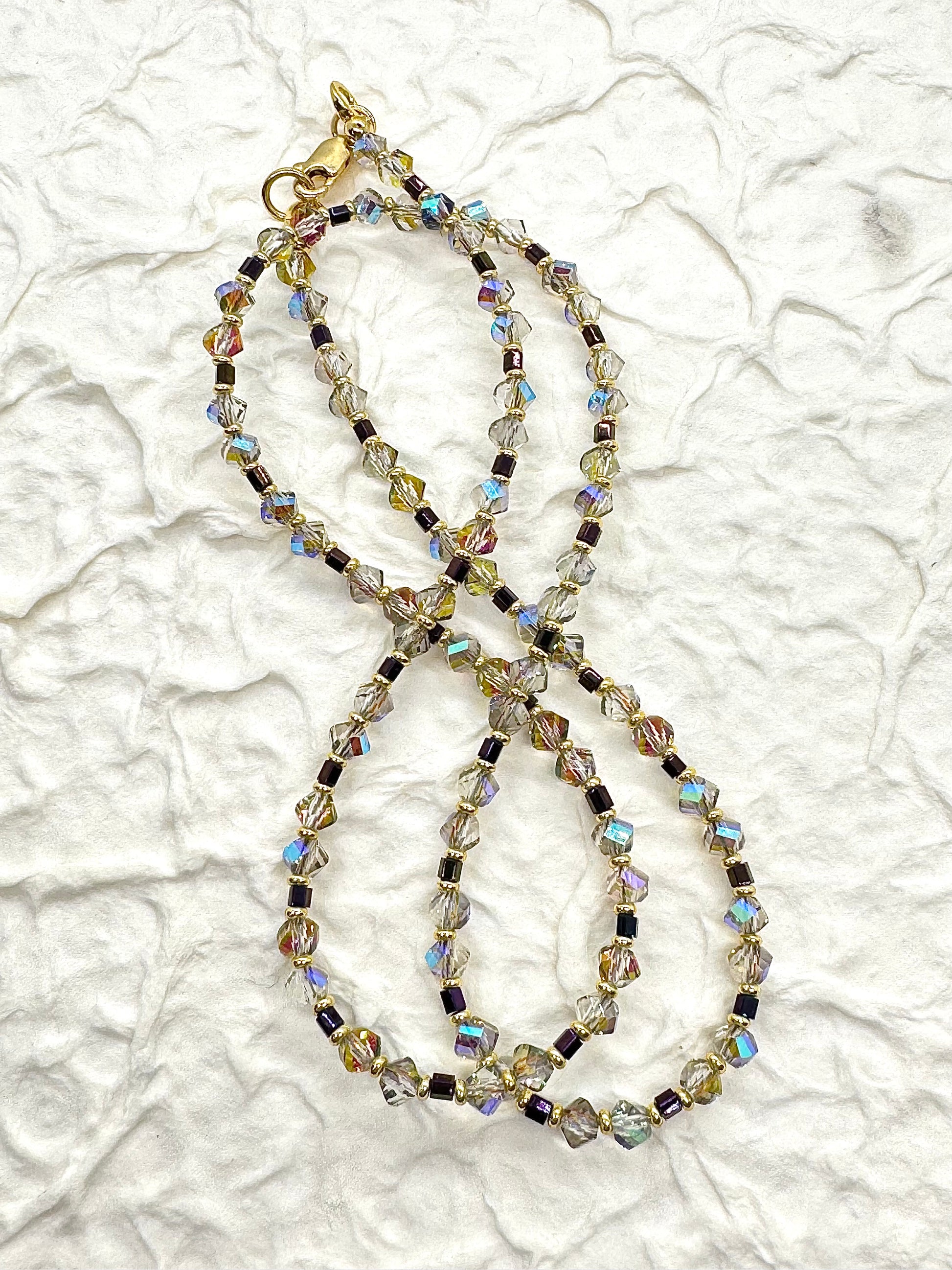 Beaded necklace on a textured white surface