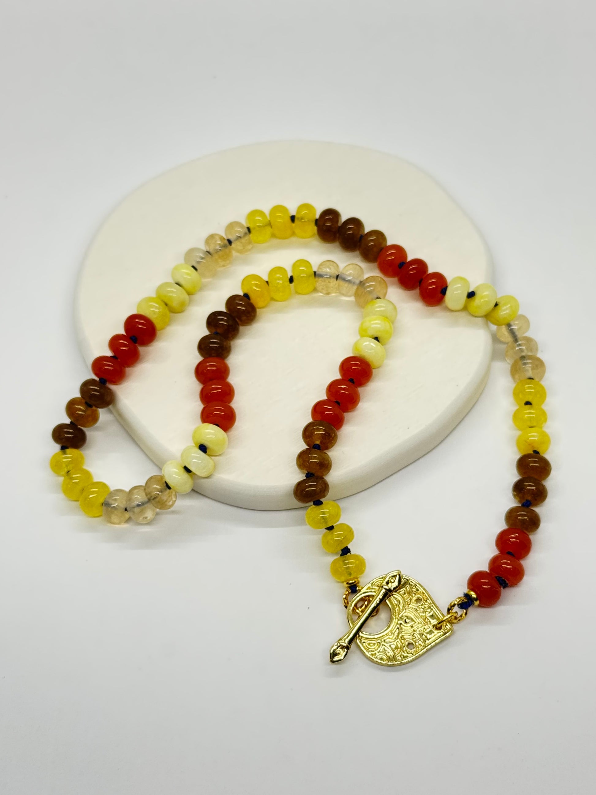 Beaded necklace with a gold clasp on a white background