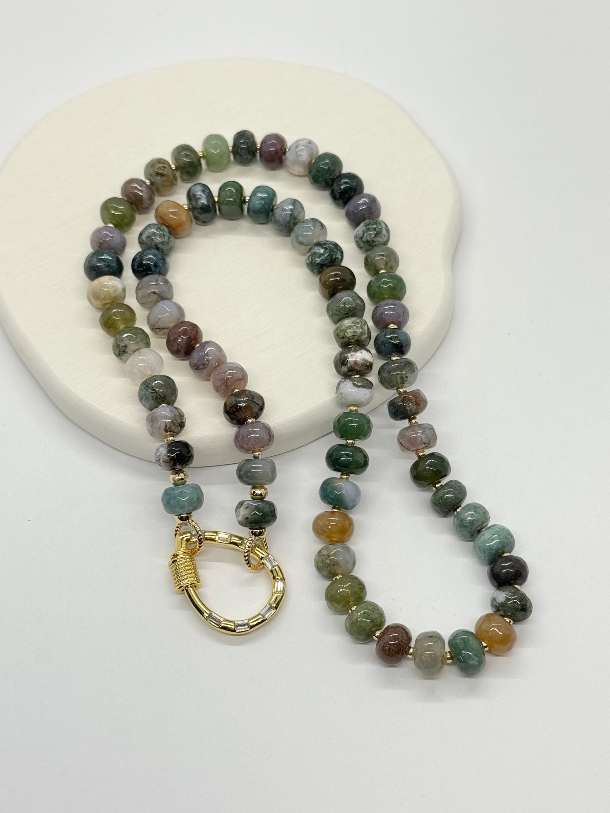 Beaded necklace with a gold clasp on a white background