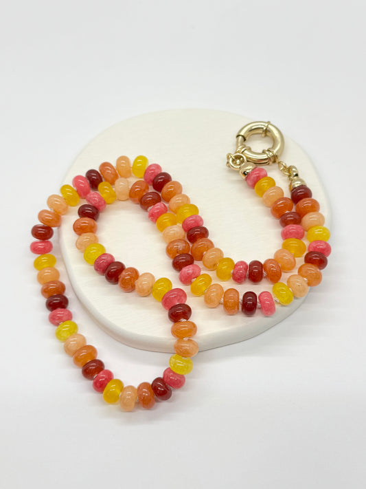 Colorful beaded necklace with a gold clasp on a white background