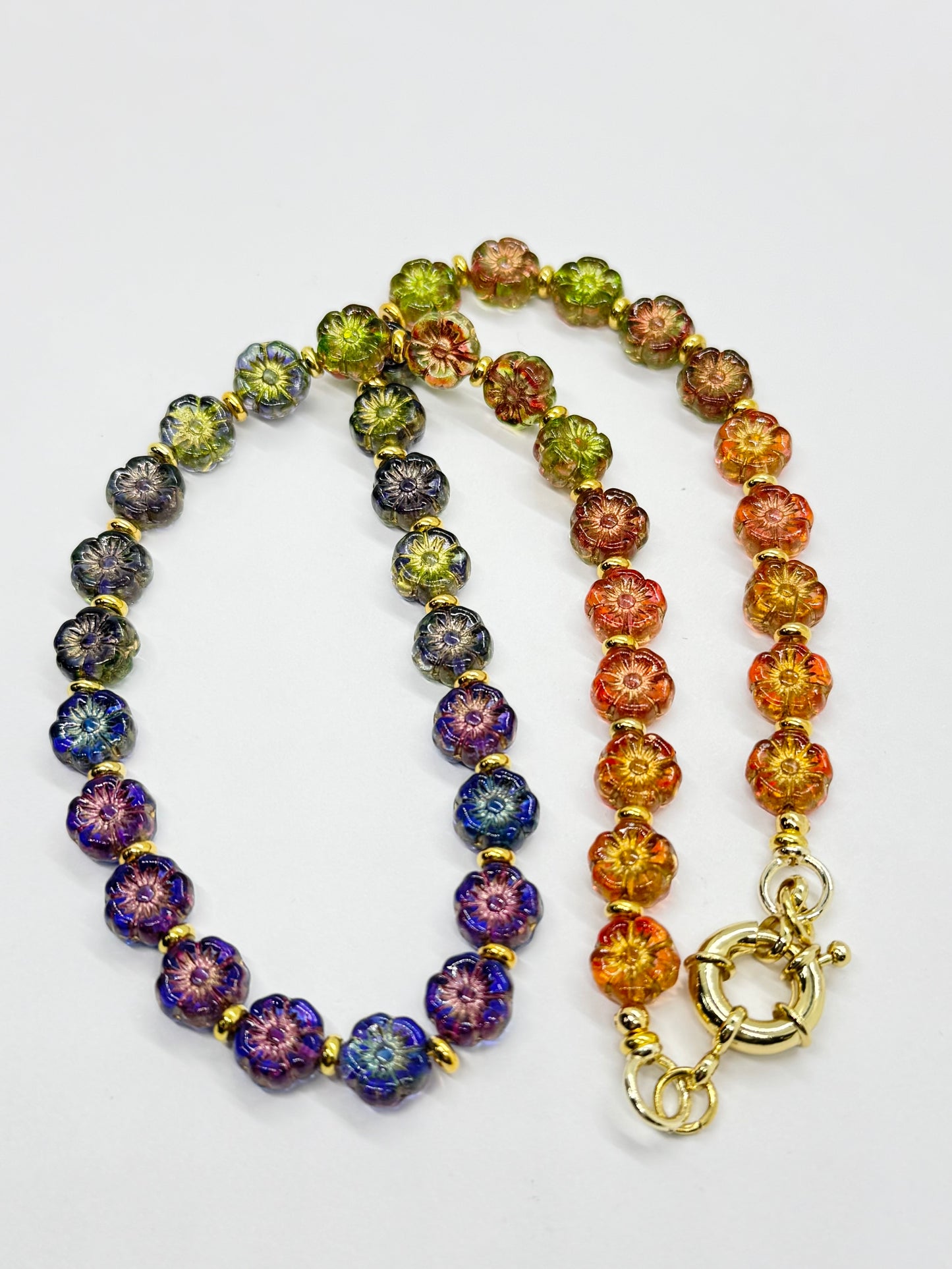 Colorful beaded necklace with a gold clasp on a white background