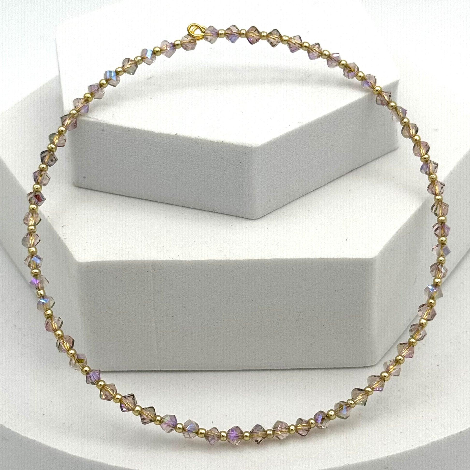 Necklace with beaded design on a white stand
