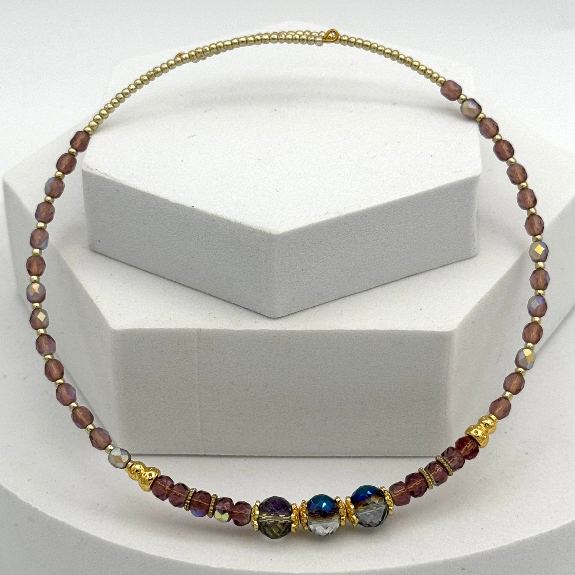 Necklace with multicolored beads on a white stand