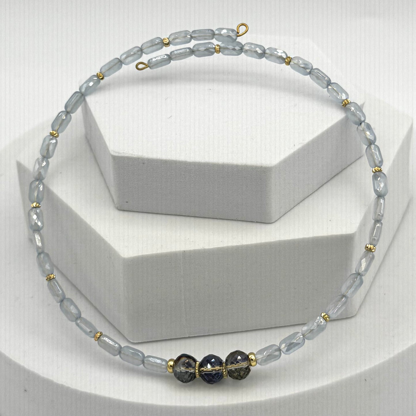 Necklace with gray and black beads on a white background
