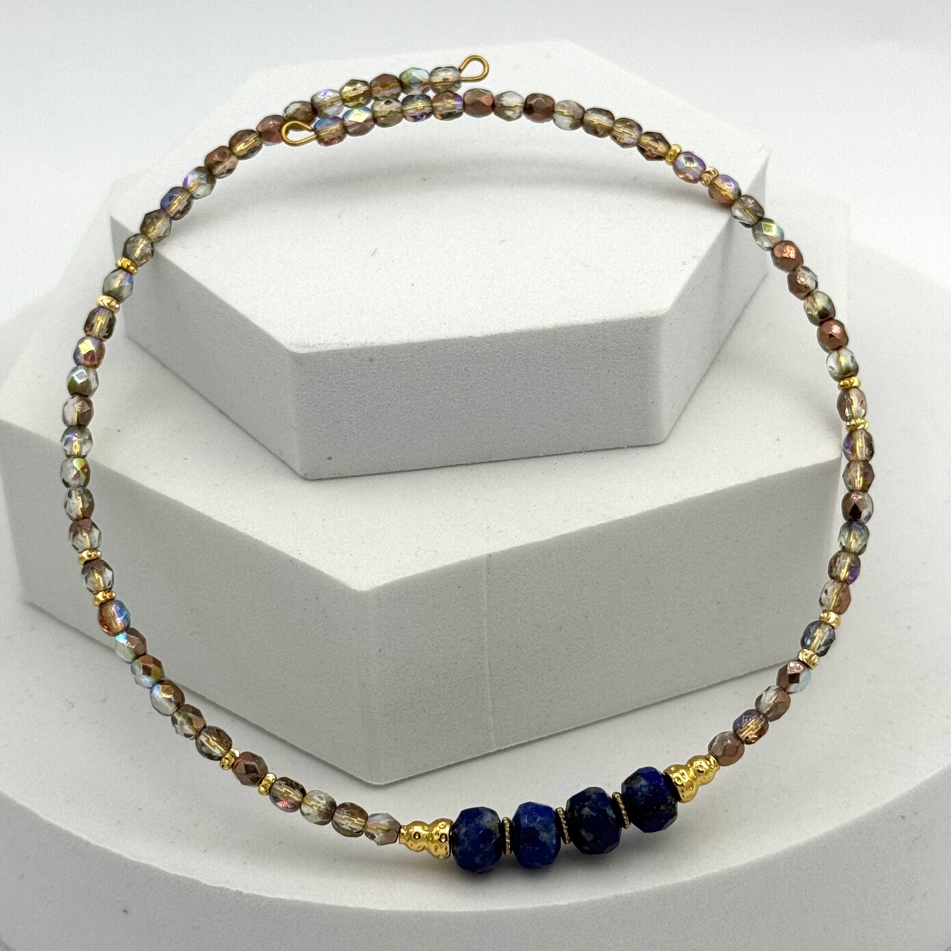Necklace with multicolored beads on a white stand