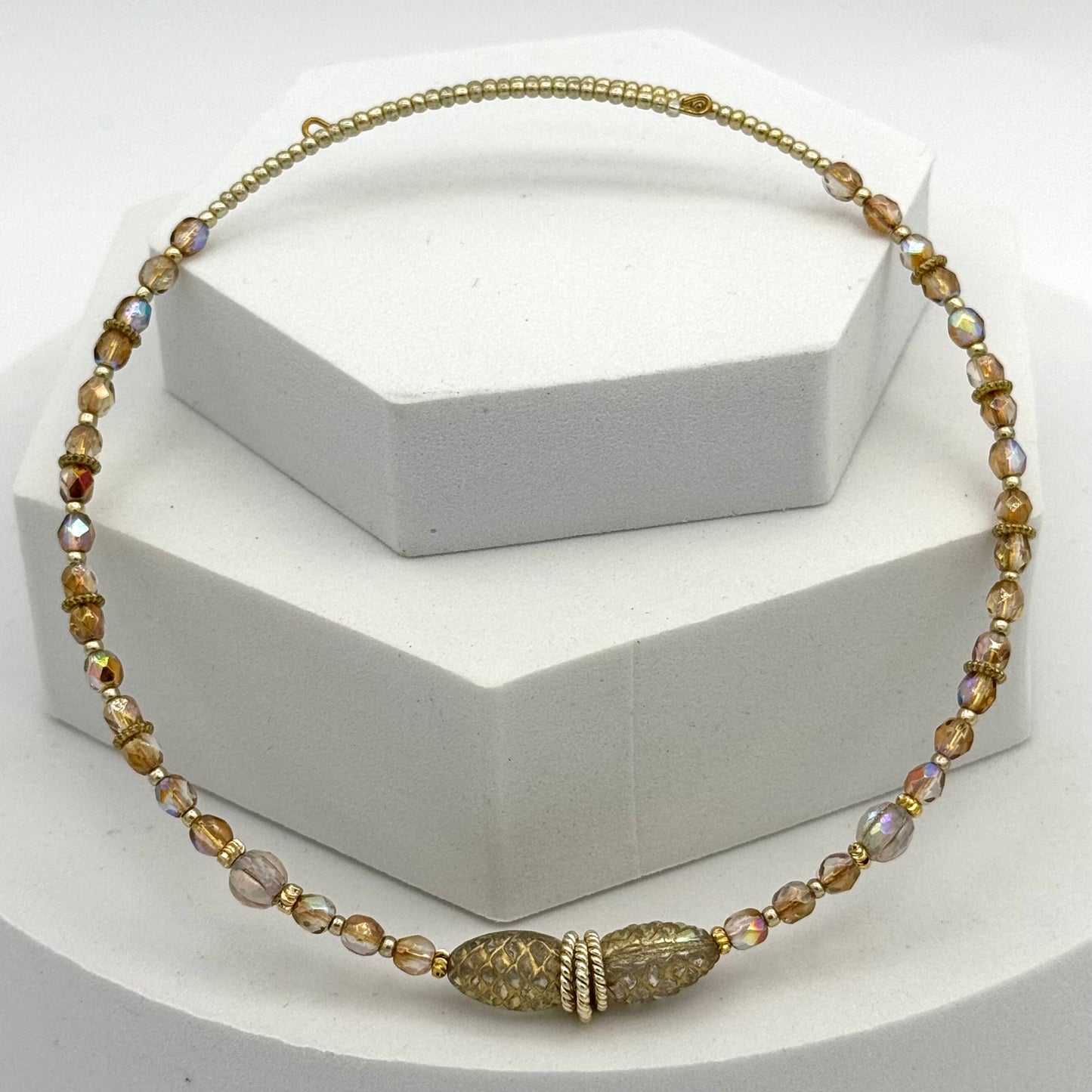 Necklace with gold and brown beads on a white background